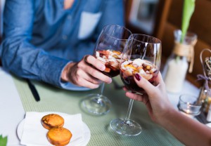 Two lovers cheering with sangria in a restaurant